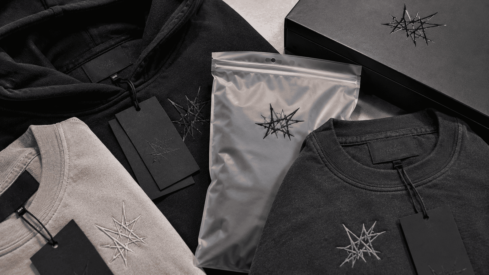 Close-up of streetwear private label customization including puff print logos, embroidery, woven labels, hang tags and premium packaging, detailed stitching and heavyweight fabric texture visible, professional apparel branding presentation, ultra realistic, high detail, no text
